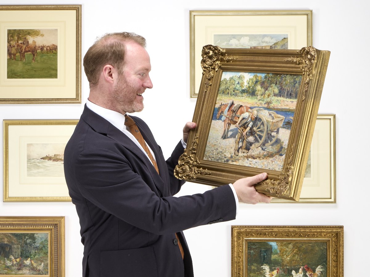 Rohan McCulloch examining a painting